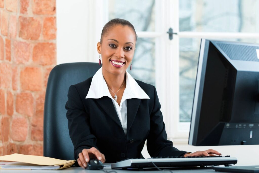 A woman sitting at her desk in front of a computer.